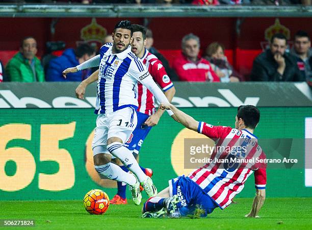 Carlos Vela of Real Sociedad duels for the ball with Sergio Alvarez of Real Sporting de Gijon during the La Liga match between Real Sporting de Gijon...