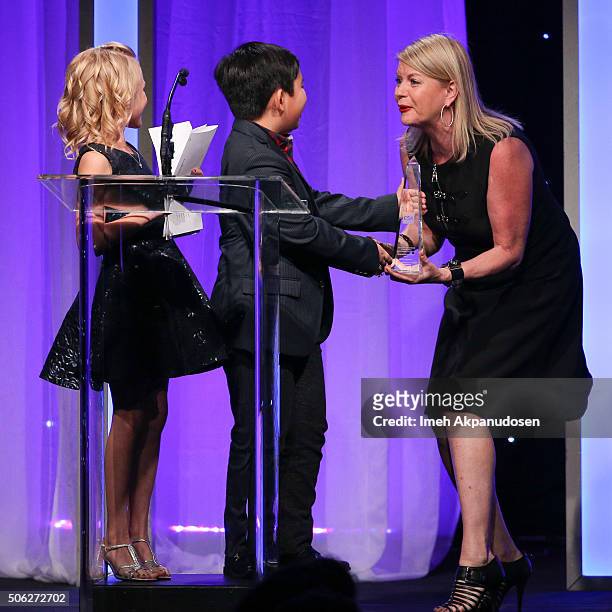 Actress Alyvia Alyn Lind and actor Albert Tsai present an award to casting director Julie Ashton-Barson onstage during the Casting Society Of...