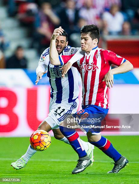 Carlos Vela of Real Sociedad duels for the ball with Jorge Mere of Real Sporting de Gijon during the La Liga match between Real Sporting de Gijon and...
