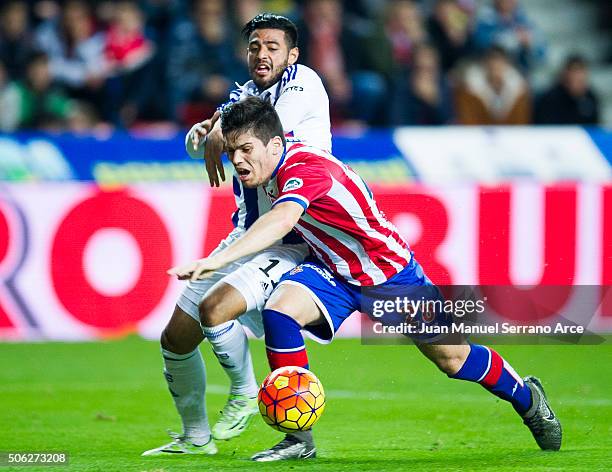 Carlos Vela of Real Sociedad duels for the ball with Jorge Mere of Real Sporting de Gijon during the La Liga match between Real Sporting de Gijon and...