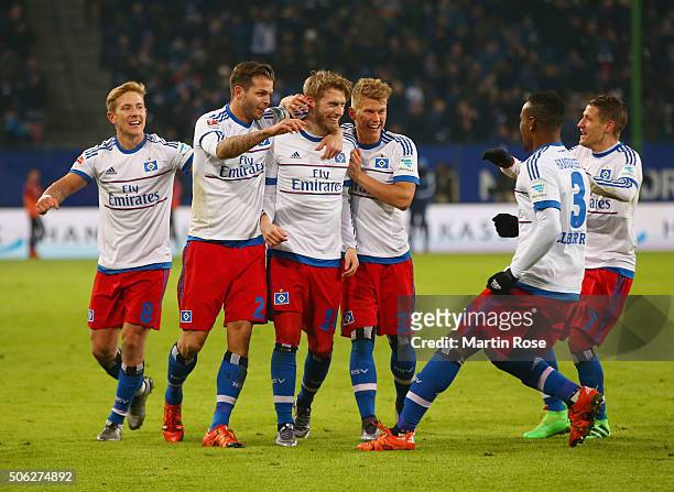 Aaron Hunt of SV Hamburg is congratulated by team mates as his free kick leads to an own goal by Xabi Alonso of Bayern Munich for their equaliser...