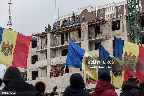 Opponent Moldavians shout slogans and carry Moldavian flags during an anti-government protest, demanding resignation of the government and early...