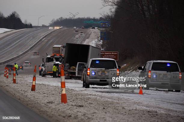 North Carolina State Troopers work an accident involving a tractor-trailer along Interstate 40/85 during a winter storm on January 22, 2016 in...