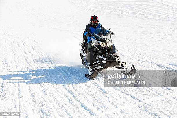 speeding on snowmobile - snowmobiling stock pictures, royalty-free photos & images