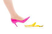 Woman in Pink Highheel Stepping on Slippery Banana Peel on White
