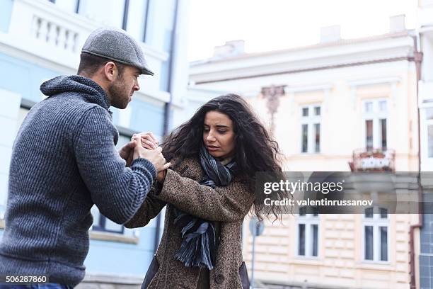 young couple with relationship problems on street - agressie stockfoto's en -beelden
