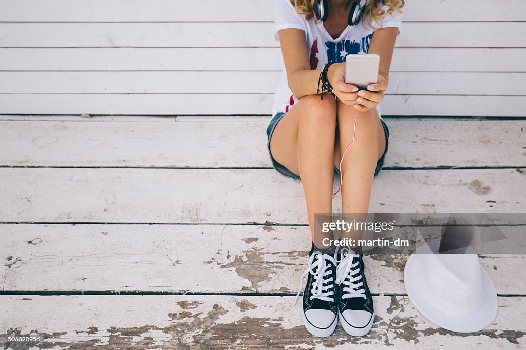 Girl texting at the veranda