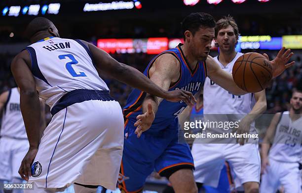 Nick Collison of the Oklahoma City Thunder dribbles the ball against Raymond Felton of the Dallas Mavericks in the first half at American Airlines...