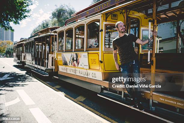 san francisco ca. - september 26: passenger ride in a cable car on september 26, 2015 in san francisco. it is the most popular way to get around the city of san fransisco. - san fransisco stock pictures, royalty-free photos & images