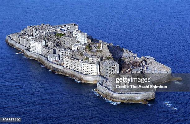 In this aerial image, a general view of the Hashima, aka the Battleship Island on March 9, 2005 in Takashima, Nagasaki, Japan. The coal mining...