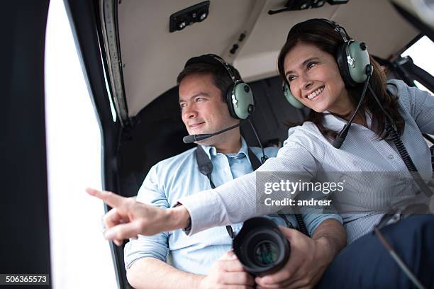 people traveling on a helicopter - helicopter window stock pictures, royalty-free photos & images