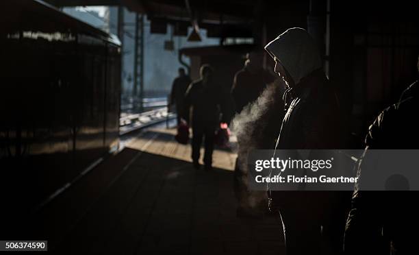 Man breaths during waiting for the tram on January 22, 2016 in Berlin.