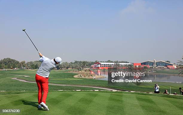 Rory McIlroy of Northern Ireland plays his tee shot at the par 5, 18th hole during the completion of the fog delayed second round of the 2016 Abu...