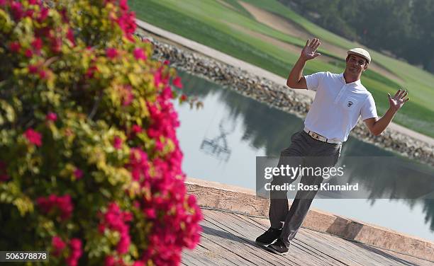 Bryson DeChambeau the amateur from the USA waves to the camera on his way on to the 7th tee during the continuation of the second round of the Abu...