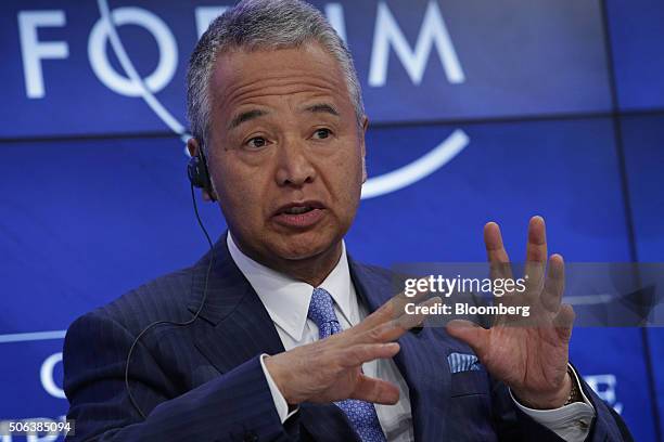 Akira Amari, Japan's economy minister, gestures whilst speaking during a panel session at the World Economic Forum in Davos, Switzerland, on...