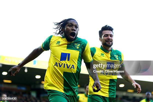 Dieumerci Mbokani of Norwich City celebrates scoring his team's first goal with his team mate Russel Martin during the Barclays Premier League match...