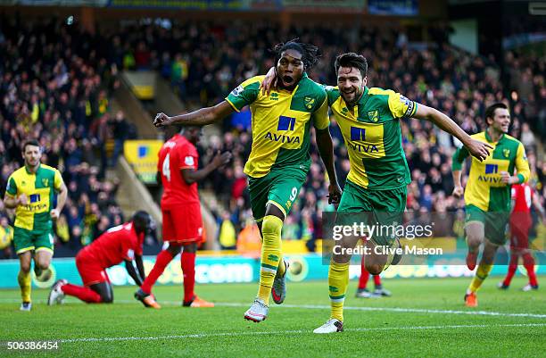 Dieumerci Mbokani of Norwich City celebrates scoring his team's first goal with his team mate Russel Martin during the Barclays Premier League match...