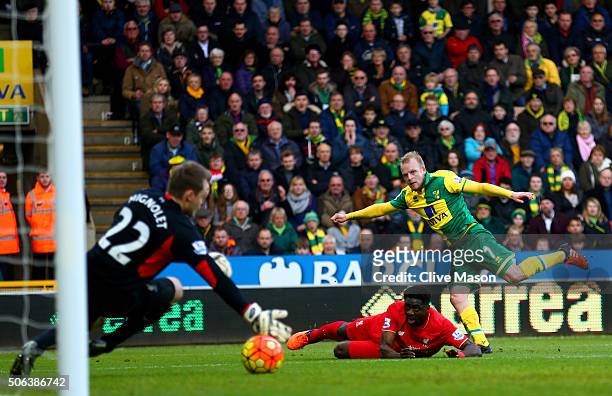 Steven Naismith of Norwich City scores his team's second goal past Simon Mignolet of Liverpool during the Barclays Premier League match between...