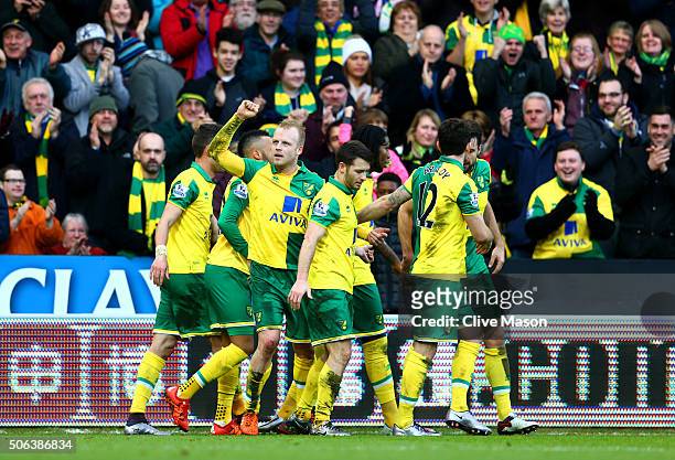 Steven Naismith of Norwich City celebrates scoring his team's second goal with his team mates during the Barclays Premier League match between...