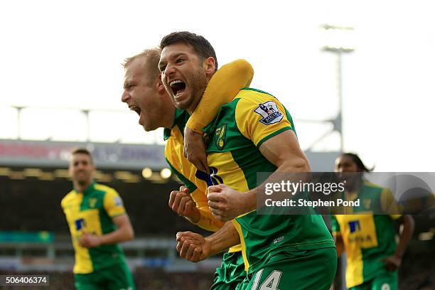 Wes Hoolahan of Norwich City celebrates scoring his team's third goal with his team mate Steven Naismith during the Barclays Premier League match...