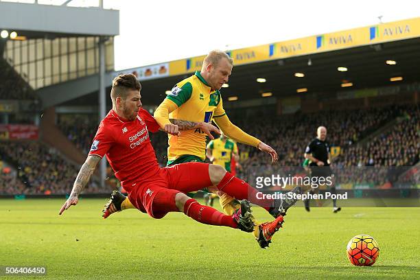 Steven Naismith of Norwich City is fouled by Alberto Moreno of Liverpool resulting in the penalty kick during the Barclays Premier League match...
