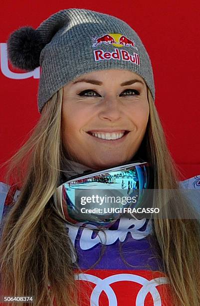 Winner US Lindsey Vonn celebrates on the podium of the FIS Alpine Skiing World Cup women's Downhill on January 23, 2016 in Cortina d'Ampezzo,...