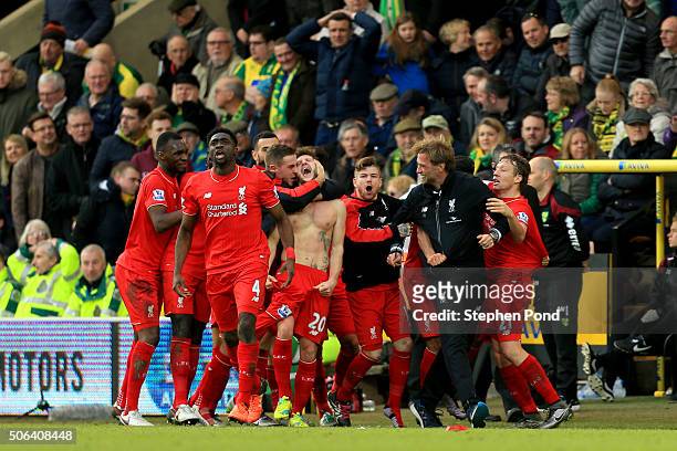 Adam Lallana of Liverpool ceelbrates scoring his team's fifth goal with his team mates and manager Jurgen Klopp during the Barclays Premier League...
