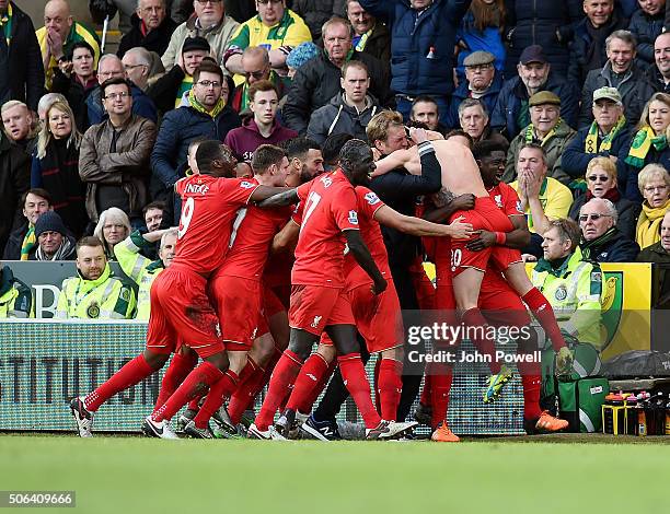 Adam Lallana of Liverpool celebrates with Jurgen Klopp manager of Liverpool and all his team mates during the Barclays Premier League match between...