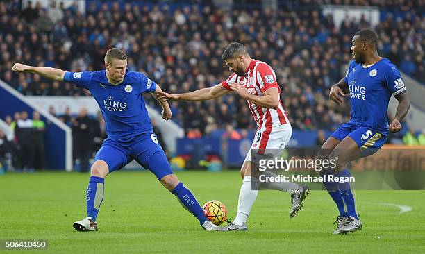 Jonathan Walters of Stoke City competes for the ball against Robert Huth and Wes Morgan of Leicester City during the Barclays Premier League match...