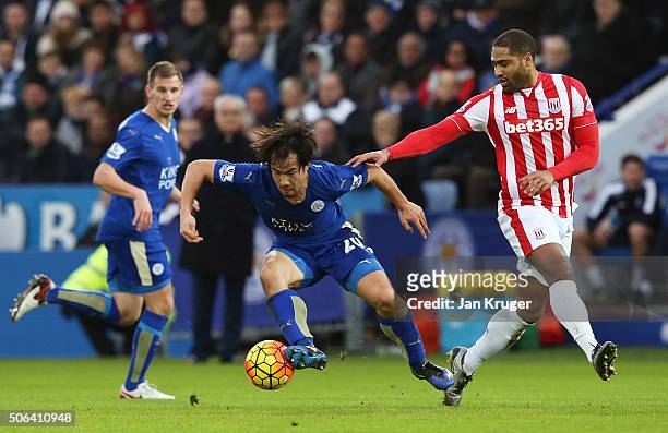 Shinji Okazaki of Leicester City and Glen Johnson of Stoke City compete for the ball during the Barclays Premier League match between Leicester City...