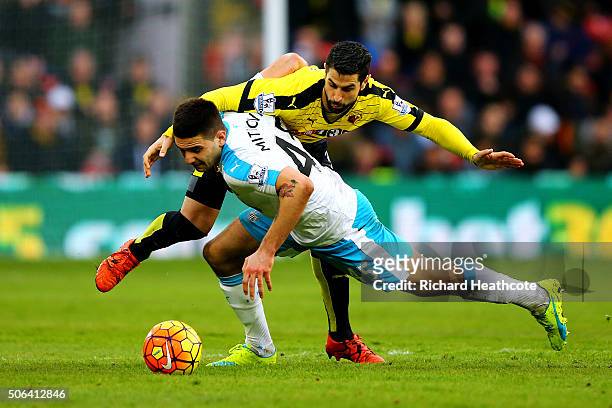 Aleksandar Mitrovic of Newcastle United is challenged by Miguel Angel Britos of Watford during the Barclays Premier League match between Watford and...