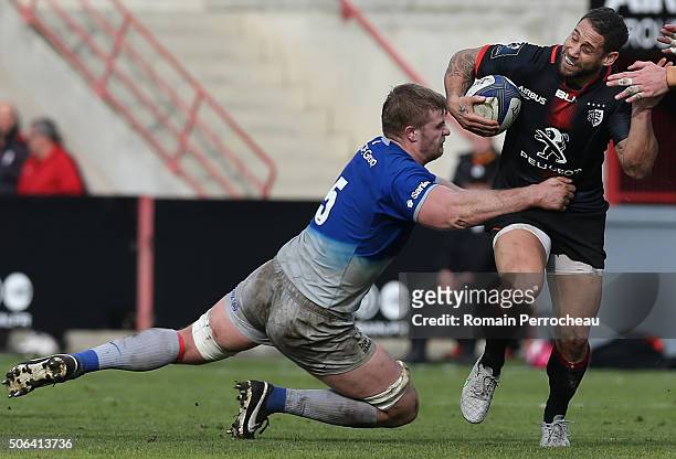 Luke Mcalister for Toulouse is tackled by George Kruis for Saracens in action during the European Rugby Champions Cup match between Toulouse and...