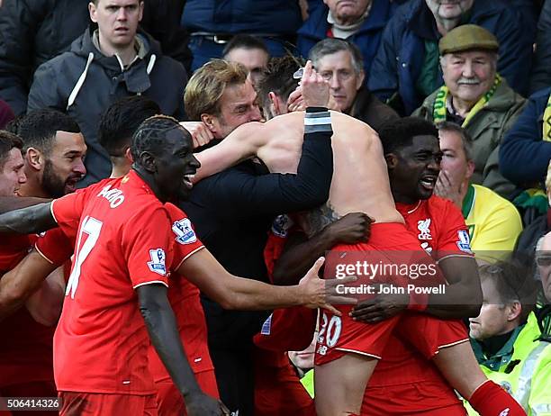 Adam Lallana of Liverpool celebrates with Jurgen Klopp manager of Liverpool and all his team mates during the Barclays Premier League match between...