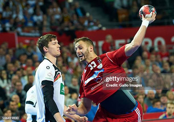 Gabor Ancsin of Hungary and Christian Dissinger of Germany during the 2 group match of the EHF European Men's Handball Championship between Germany...