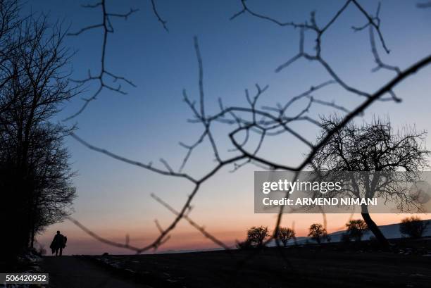 The silhouette of man is seen as he walks after crossing the Macedonian border with other migrants and refugees into Serbia, near the village of...