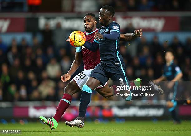 Michail Antonio of West Ham United and Bacary Sagna of Manchester City battle for the ball during the Barclays Premier League match between West Ham...