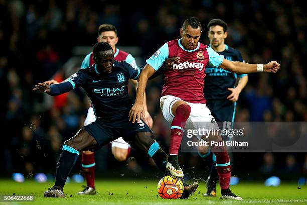 Dimitri Payet of West Ham United is challenged by Bacary Sagna of Manchester City during the Barclays Premier League match between West Ham United...