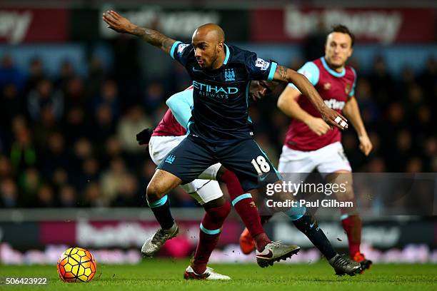 Fabian Delph of Manchester City evades Cheikhou Kouyate of West Ham United during the Barclays Premier League match between West Ham United and...