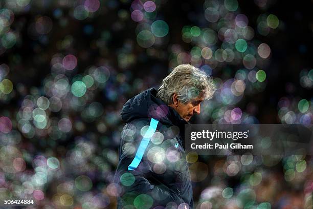 Manuel Pellegrini manager of Manchester City looks despondent as bubbles fill the air during the Barclays Premier League match between West Ham...