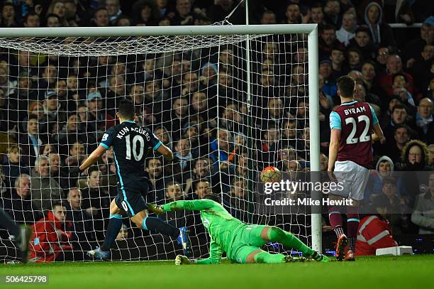 Sergio Aguero of Manchester City beats goalkeeper Adrian of West Ham United to score their second goal during the Barclays Premier League match...