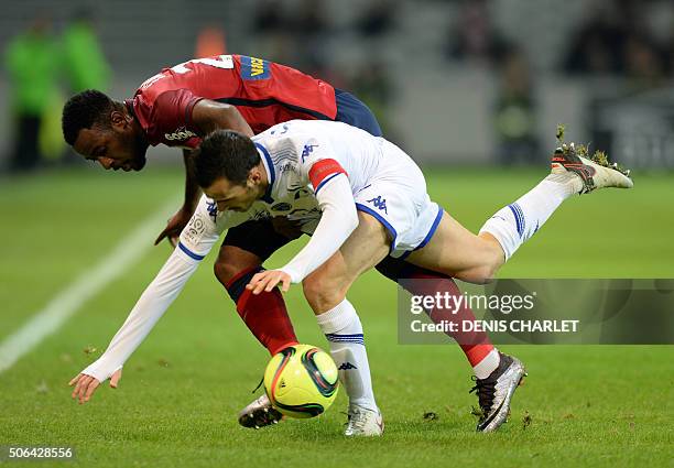 Lille's Ivorian forward Junior Tallo vies with Troyes' French defender Matthieu Saunier during the French L1 football match between Lille and Troyes...