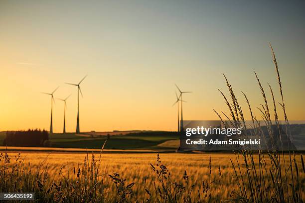 power generating wind turbines - turbine stock pictures, royalty-free photos & images