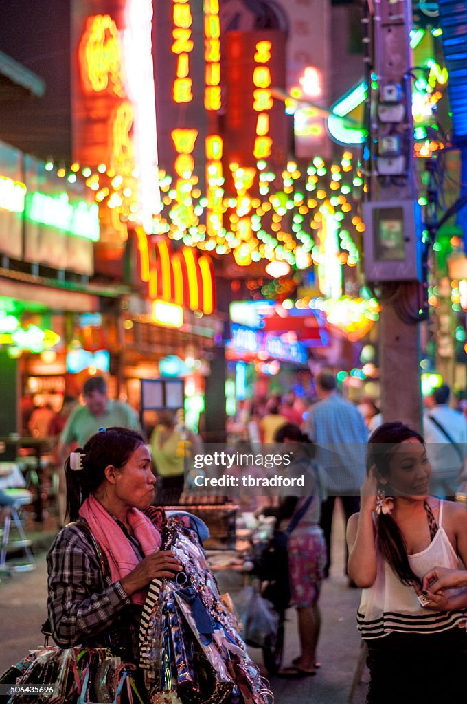 Women Look A Street Vendors Goods In Soi Cowboy, Bangkok