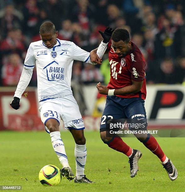 Lille's Ivorian forward Junior Tallo vies with Troyes' midfielder Calvin Ngcongca during the French L1 football match between Lille and Troyes at...