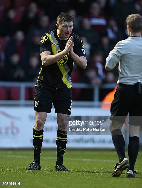 Adam Dugdale of Morecambe holds his hands in prayer as referee Gavin Ward makes his point during the Sky Bet League Two match between Northampton...