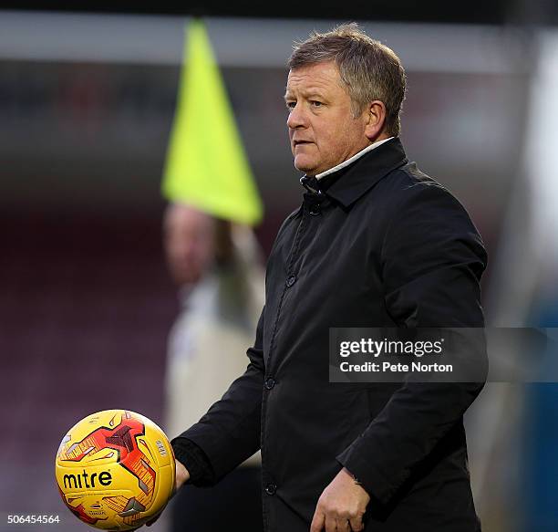 Northampton Town manager Chris Wilder returns the ball as he looks on during the Sky Bet League Two match between Northampton Town and Morecambe at...