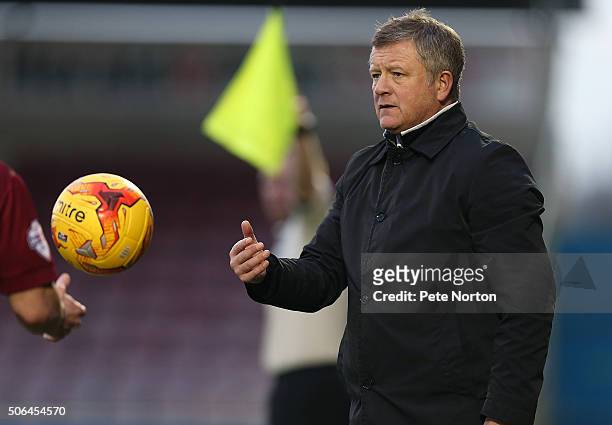 Northampton Town manager Chris Wilder returns the ball as he looks on during the Sky Bet League Two match between Northampton Town and Morecambe at...