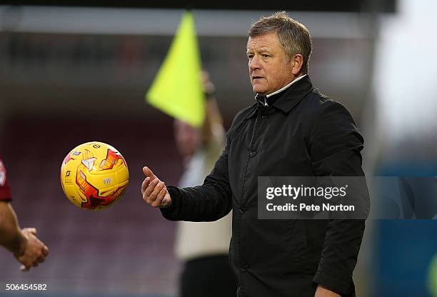 Northampton Town manager Chris Wilder returns the ball as he looks on during the Sky Bet League Two match between Northampton Town and Morecambe at...