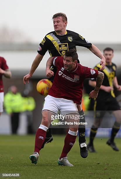 Marc Richards of Northampton Town contests the ball with Andy Parrish of Morecambe during the Sky Bet League Two match between Northampton Town and...