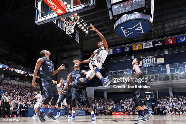 Edmond Sumner of the Xavier Musketeers drives to the basket past Angel Delgado and Isaiah Whitehead of the Seton Hall Pirates in the second half of...